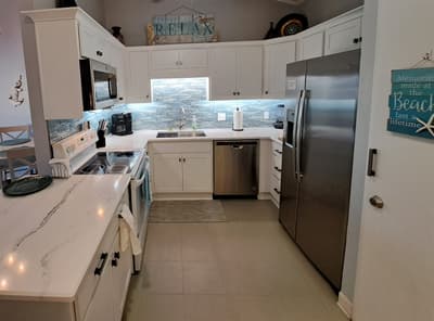 Brand new kitchen cabinets with quartz countertops and sea-glass backsplash